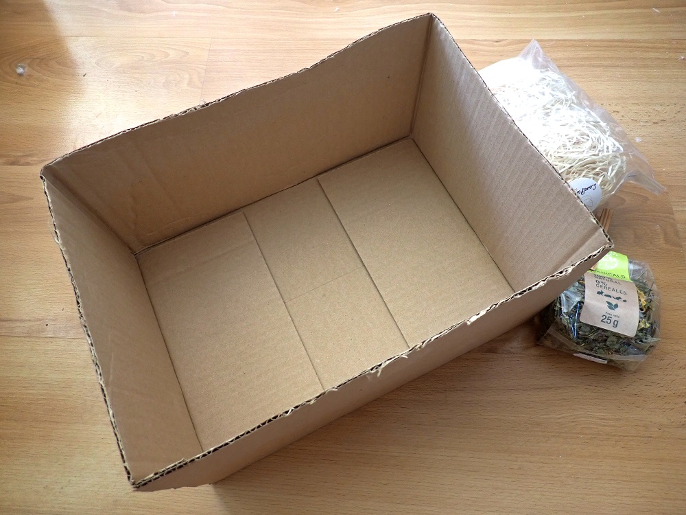 Necessary materials for a homemade parrot foraging box.